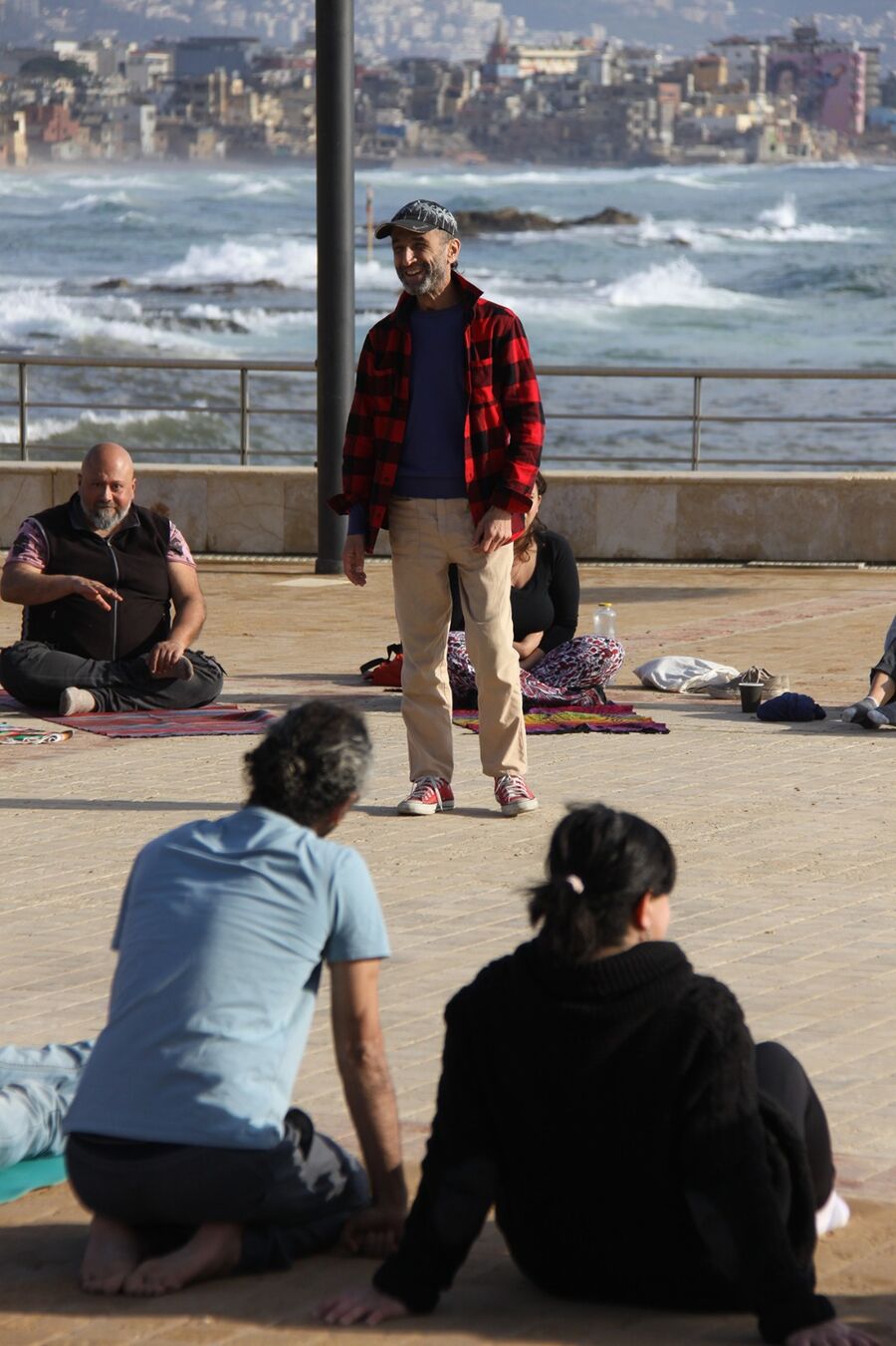 Sam guiding a group beside the sea